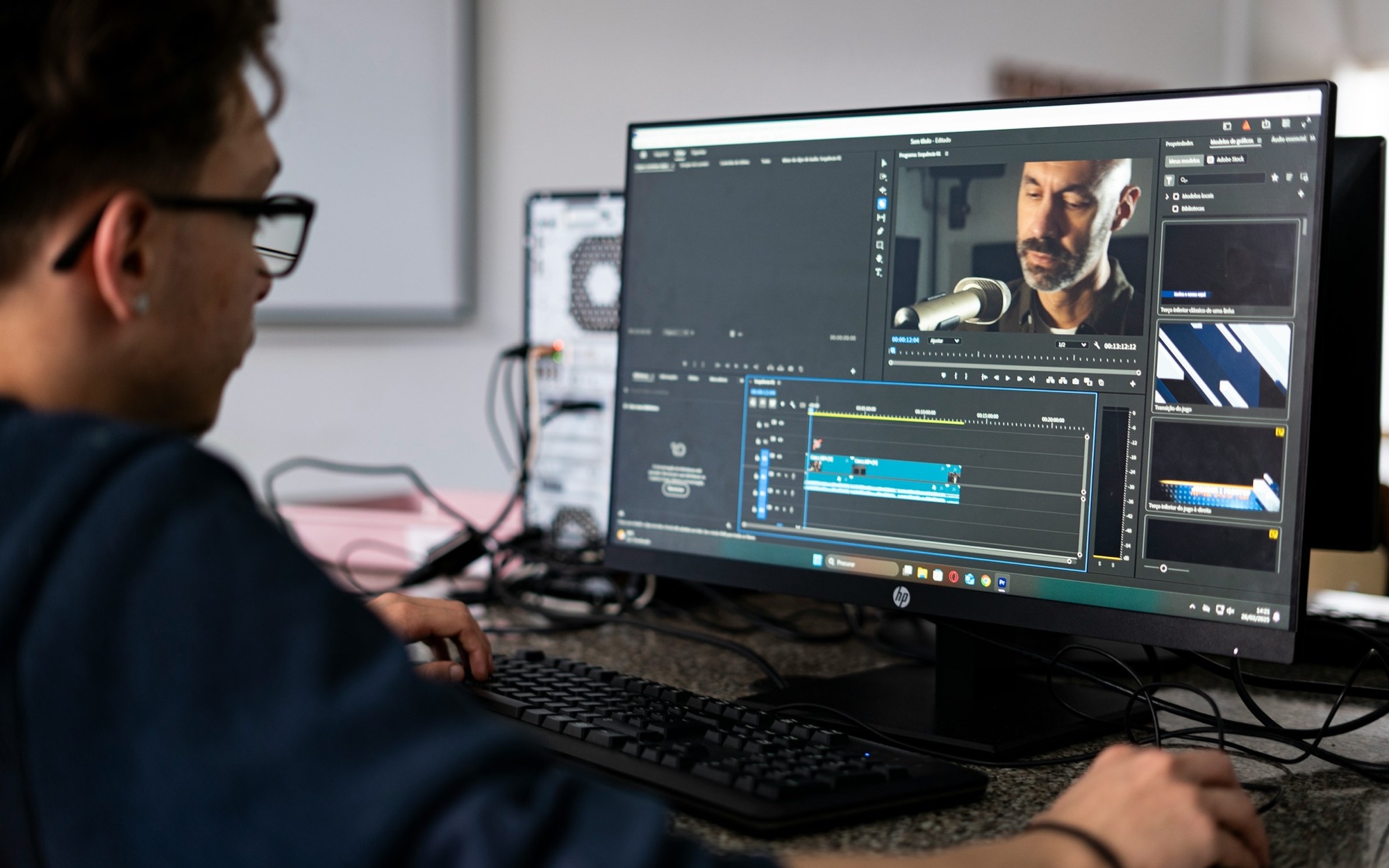 A real video editor working in Adobe Premiere Pro on a professional desktop monitor